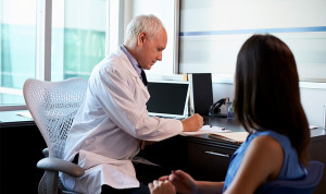 Un médico atiende a una mujer en su consulta de Atención Primaria. 