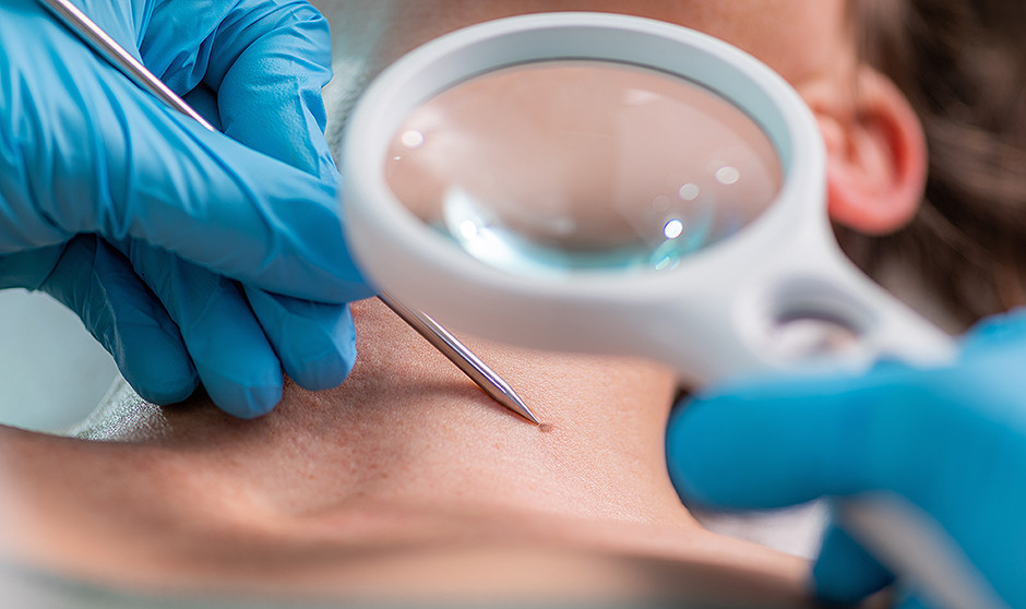 Un dermatólogo atendiendo a un paciente.